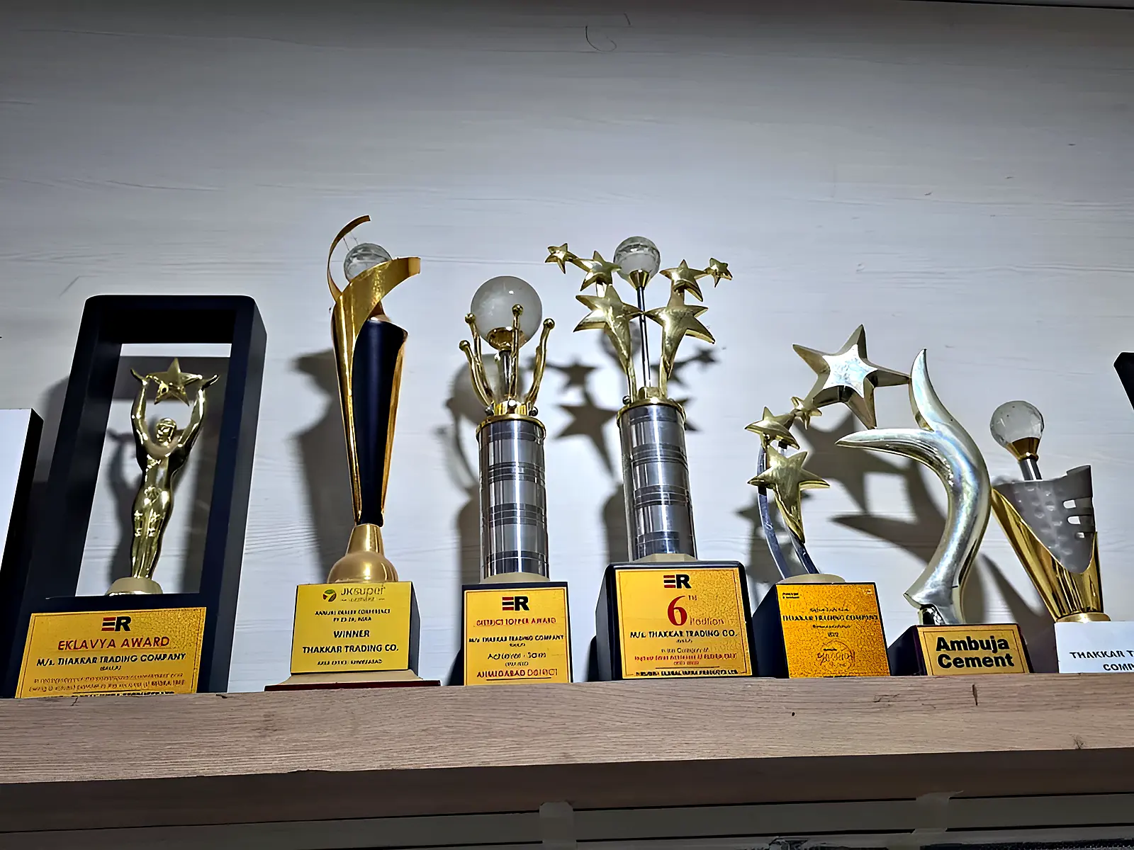 Trophies and awards on a shelf at the Thakkar Trading Co. office